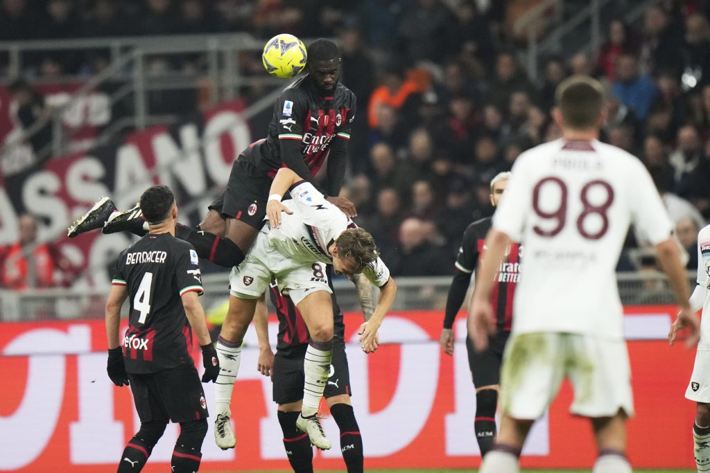 AC Milan's Fikayo Tomori, top and Salernitana's Emil Bohinen challenge for the ball during a Serie A soccer match between AC Milan and Salernitana at the San Siro stadium in Milan, Italy, Monday, March 13, 2023. (AP Photo/Luca Bruno)
