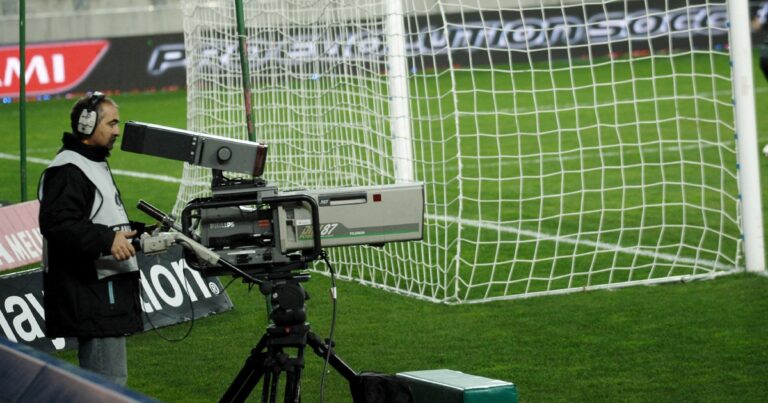 (FILES) A cameraman films at the Bonal Stadium in Sochaux on March 1, 2008, during the Ligue 1 football match between Sochaux and Rennes. The French football league (LFP) announced on July 1, 2025 the creation of its own channel to broadcast Ligue 1 matches next season, after clubs voted in favour of ending a deal with DAZN. An agreement was struck for a "TV and digital platform entirely dedicated to Ligue 1" following a meeting of club presidents, the LFP's board of directors and representatives of its commercial arm, LFP Media.The new channel will show eight of nine matches each weekend, with Qatar's beIN Sports keeping the rights to broadcast the remaining game. (Photo by Jeff PACHOUD / AFP)