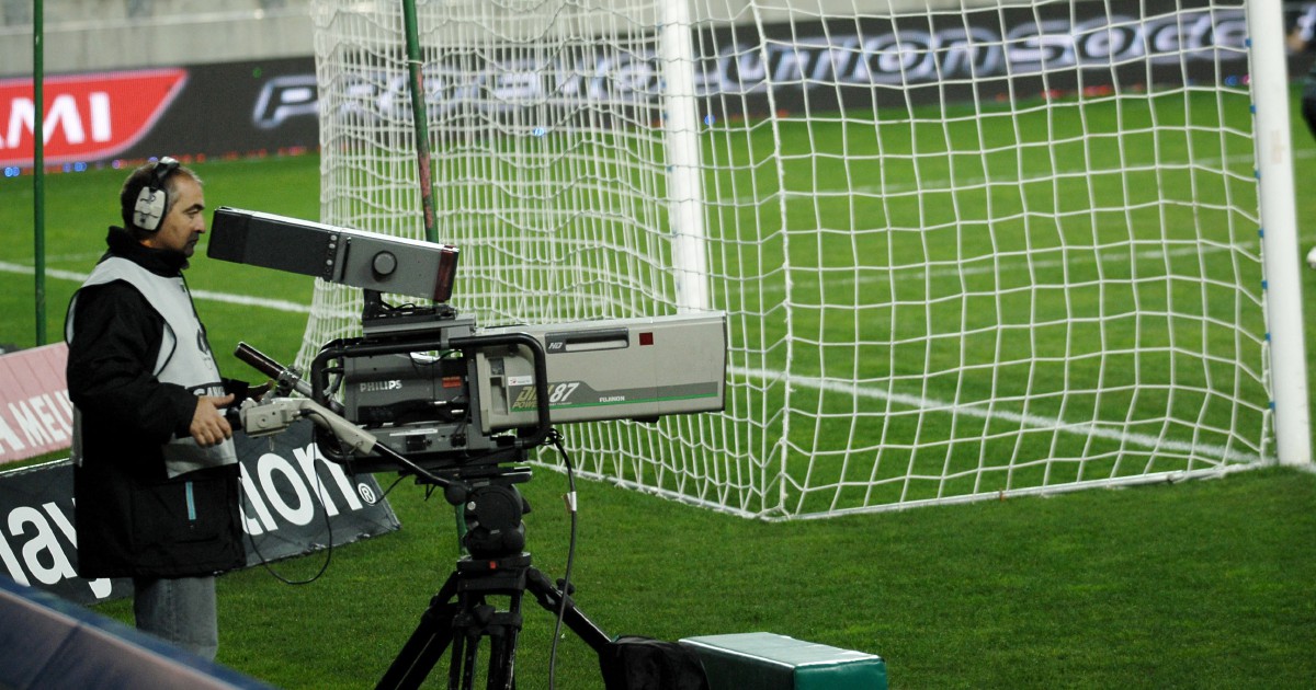 (FILES) A cameraman films at the Bonal Stadium in Sochaux on March 1, 2008, during the Ligue 1 football match between Sochaux and Rennes. The French football league (LFP) announced on July 1, 2025 the creation of its own channel to broadcast Ligue 1 matches next season, after clubs voted in favour of ending a deal with DAZN. An agreement was struck for a "TV and digital platform entirely dedicated to Ligue 1" following a meeting of club presidents, the LFP's board of directors and representatives of its commercial arm, LFP Media.The new channel will show eight of nine matches each weekend, with Qatar's beIN Sports keeping the rights to broadcast the remaining game. (Photo by Jeff PACHOUD / AFP)